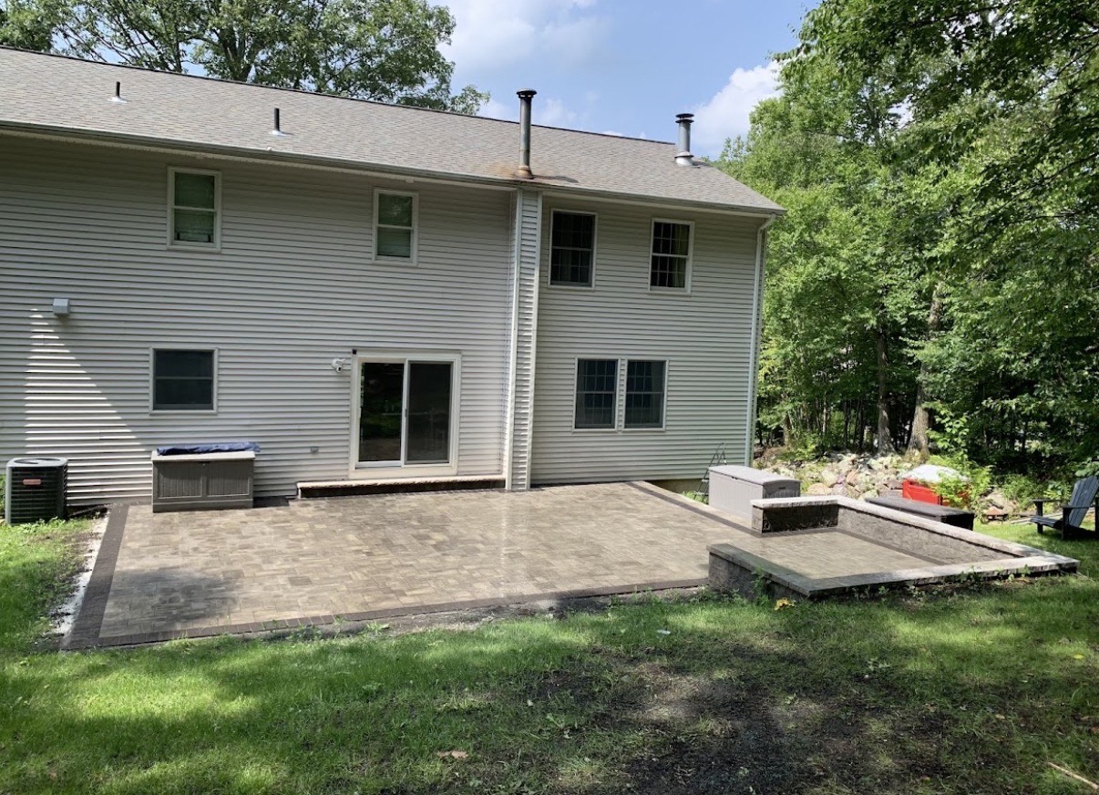 Backyard paver patio with seating wall